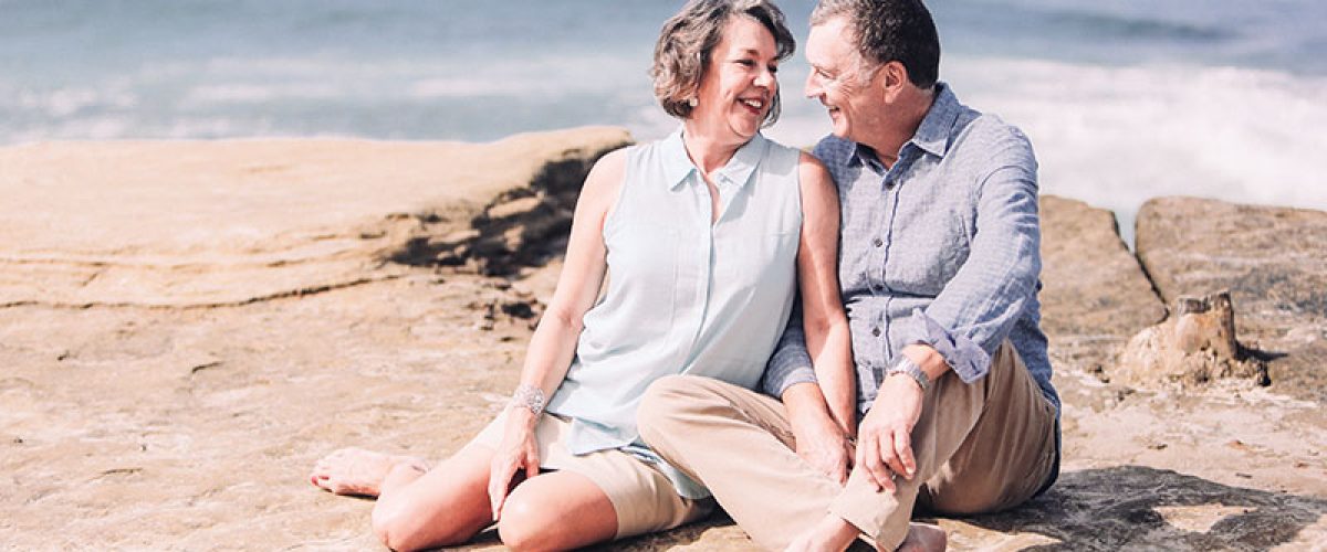 an-elderly-baby-boomer-couple-shares-a-romantic-moment-and-enjoying-their-company-at-the-beach_resize