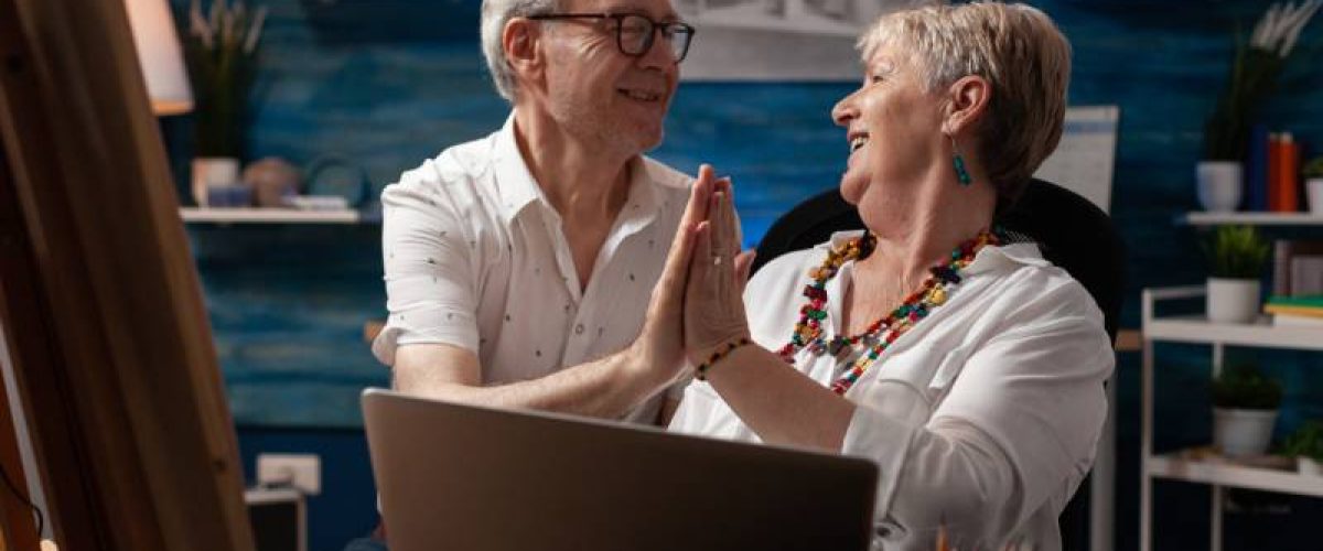 elderly-artist-couple-holding-laptop-touching-hand-2023-11-27-05-07-59-utc (1) (1)