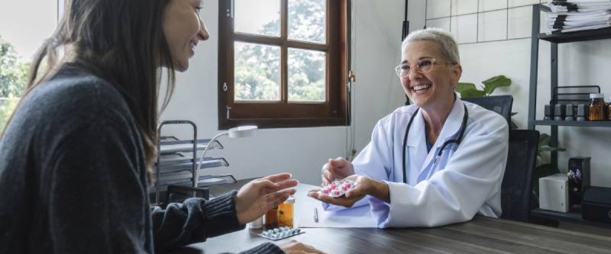 elderly-female-doctor-in-white-coat-talking-with-b-2023-11-27-04-49-29-utc (1)