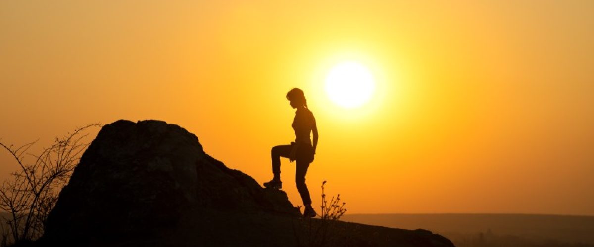 silhouette-of-a-woman-hiker-climbing-up-a-big-ston-2022-08-19-05-57-16-utc_ffet