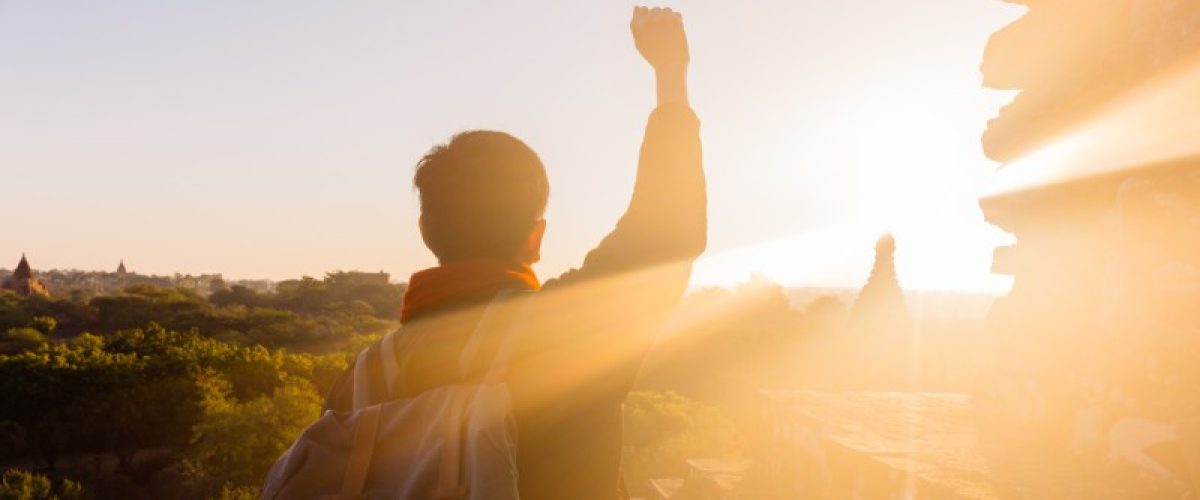 young-man-raising-hands-up-against-sunlight-indi-2022-12-16-09-59-29_fet